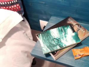 two books sitting on a table next to a bed at 14 B&B in Sassari