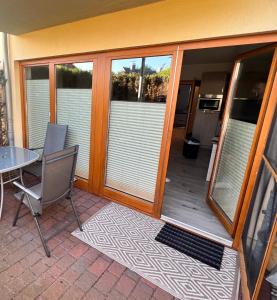 a screened in porch with a table and chairs at Ostseeperle Zingst, strandnahes 3-Zimmer Apartment in Zingst