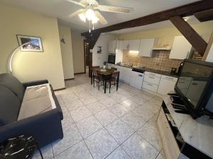 a living room and kitchen with a couch and a table at Appartement à Mitzach in Mitzach