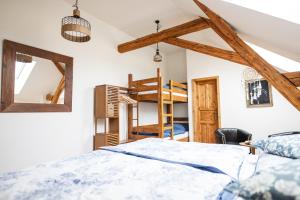a bedroom with a bed and two bunk beds at Farma Mlýn Drásov in Drásov