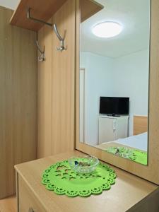 a room with a mirror and a bowl on a table at Studio Ariel in Veľký Meder