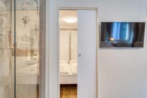 a sliding glass door with a television in a room at HITrental Eisengasse Apartments in Lucerne +38 photos