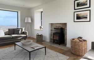 a living room with a couch and a fireplace at Taigh Druim in Elgol +33 photos