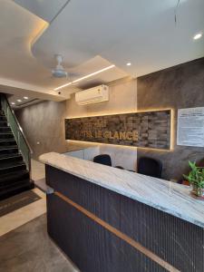 a lobby of a office with a counter and stairs at Hotel Le Glance Rooms & Dormitory in Mumbai