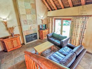 a living room with a couch and a table at Cherry Creek at Zebula in Warmbaths