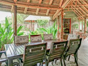 a wooden table and chairs on a patio at Cherry Creek at Zebula in Warmbaths