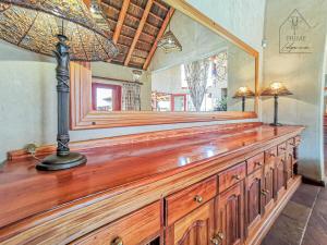 a large wooden dresser with a mirror on top of it at Cherry Creek at Zebula in Warmbaths +40 photos