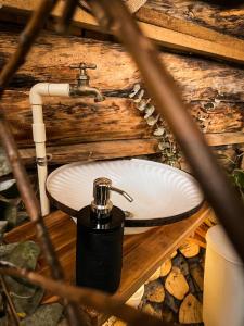 a bathroom sink with a soap dispenser on it at Cabaña el Leñador in Santa Elena +16 photos