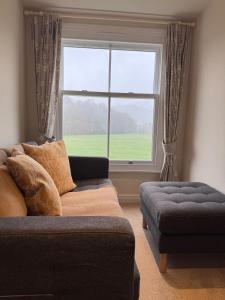 a living room with a couch and a large window at Springfield House in Grasmere