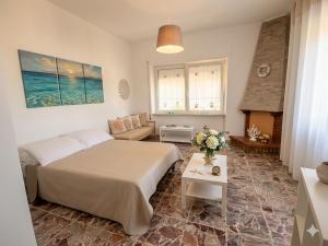 a bedroom with a bed and a living room at Casa Matilde e Aurora GIARDINO e POSTO AUTO in Sirolo