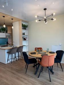 a kitchen and dining room with a table and chairs at Weekend apartment 3 in Sigulda