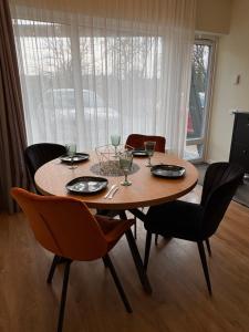 a dining room table with chairs and a table and chairsktop at Weekend apartment 3 in Sigulda
