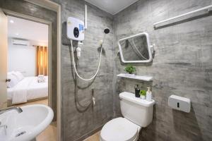 a bathroom with a shower and a toilet and a sink at Similan Mondo Resort & Camping in Phang-nga +86 photos