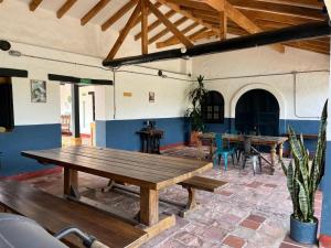 a wooden table in a room with tables and chairs at Hotel Aceitunos in Villa de Leyva +41 photos