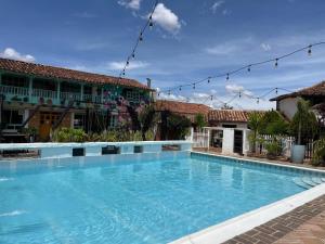 a large swimming pool in front of a building at Hotel Aceitunos in Villa de Leyva