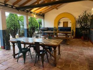 a large patio with a wooden table and chairs at Hotel Aceitunos in Villa de Leyva