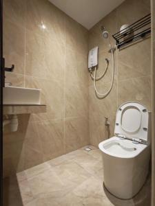 a bathroom with a toilet and a sink at The Loft hotel 68 in Butterworth