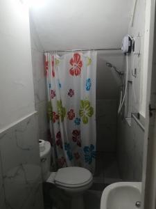 a bathroom with a toilet and a shower curtain at Punta hermosa casa playa in Punta Hermosa