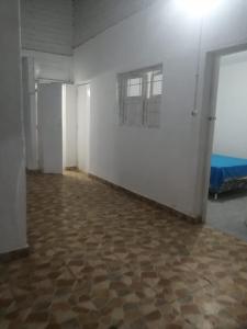 an empty room with a white wall and a floor at Punta hermosa casa playa in Punta Hermosa +3 photos