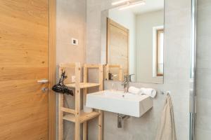 a bathroom with a sink and a mirror at Nest Family, Bedollo Ospitar in Bedollo +34 photos