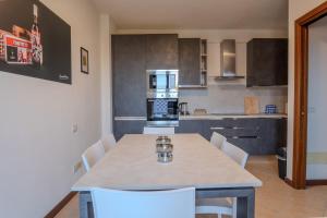 a kitchen with a table and chairs in a room at Relais Terre Divino 1 in Ponton +13 photos