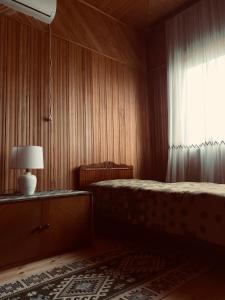 a bedroom with two beds and a window at Brick House Melodies in Tsqaltubo