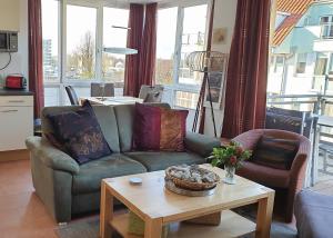a living room with a couch and a table at Meerblick 9 - Großenbrode in Grossenbrode