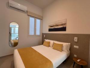 a bedroom with a large bed with yellow pillows at Iberflat San Gregorio in Seville