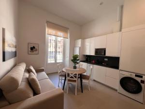 a living room with a couch and a table at Iberflat San Gregorio in Seville