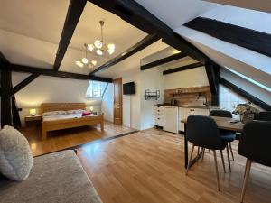 a living room with a bed and a dining room at Pension Rosa in Český Krumlov