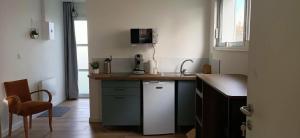 a kitchen with a sink and a dishwasher at Studio85 in La Gaubretière