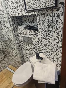 a bathroom with a white toilet and a sink at Zakątek Spokoju in Toruń