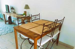 a wooden table and chairs in a room at Gîtes Arvor et Tevenn in Saint-Brevin-les-Pins
