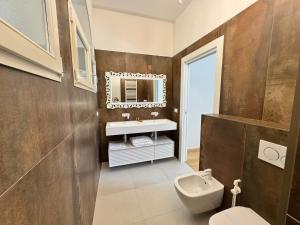 a bathroom with a sink and a toilet and a mirror at Santa Caterina 1604 Suites in Anzola dell'Emilia +76 photos