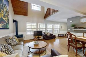 a living room with a couch and a table at Tranquil cabin near ski slopes & trails with wraparound deck & pool table in Truckee