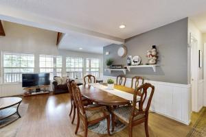 a dining room with a table and chairs at Tranquil cabin near ski slopes & trails with wraparound deck & pool table in Truckee