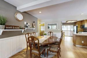 a kitchen and dining room with a table and chairs at Tranquil cabin near ski slopes & trails with wraparound deck & pool table in Truckee
