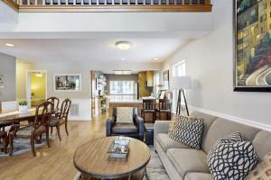 a living room with a couch and a table at Tranquil cabin near ski slopes & trails with wraparound deck & pool table in Truckee +28 photos