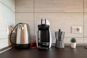 a coffeemaker sitting on top of a kitchen counter at Victory76 - Hospital, M3, Linate in San Donato Milanese