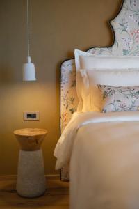a bedroom with a bed and a pendant light at Josefina unique hotel, adult only in Kozina +67 photos