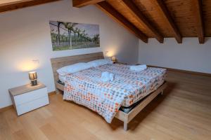 a bedroom with a bed and a night stand with two lamps at Relais Terre Divino 1 in Ponton