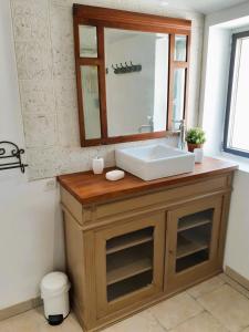 a bathroom with a sink and a mirror at Gîtes Arvor et Tevenn in Saint-Brevin-les-Pins +48 photos