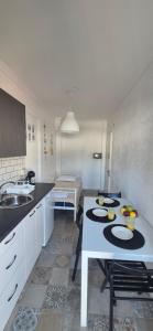 a kitchen with a table with plates on it at Sea home Asprovalta in Asprovalta +20 photos