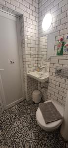 a white bathroom with a toilet and a sink at Sea home Asprovalta in Asprovalta