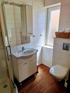 a bathroom with a sink and a toilet at Apartments Dalmacija in Podstrana +50 photos