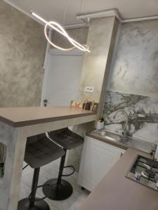 a small kitchen with a counter and a sink at Edward Luxury Studio in Slănic-Moldova