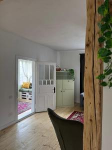 a living room with a door open to a bedroom at zelena khata in Sopot