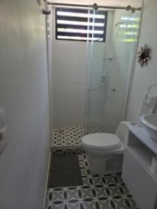 a bathroom with a shower and a toilet and a sink at Cabañas Annapurna - Cabaña #12 in Taganga +9 photos