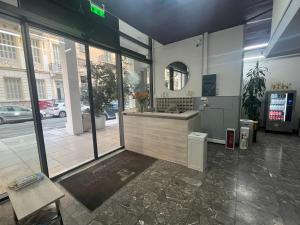 a lobby of a building with a sink and a mirror at Paloma in Athens