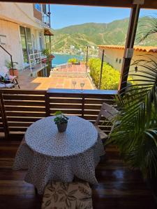 a table with a potted plant sitting on a patio at Cabañas Annapurna - Cabaña #12 in Taganga